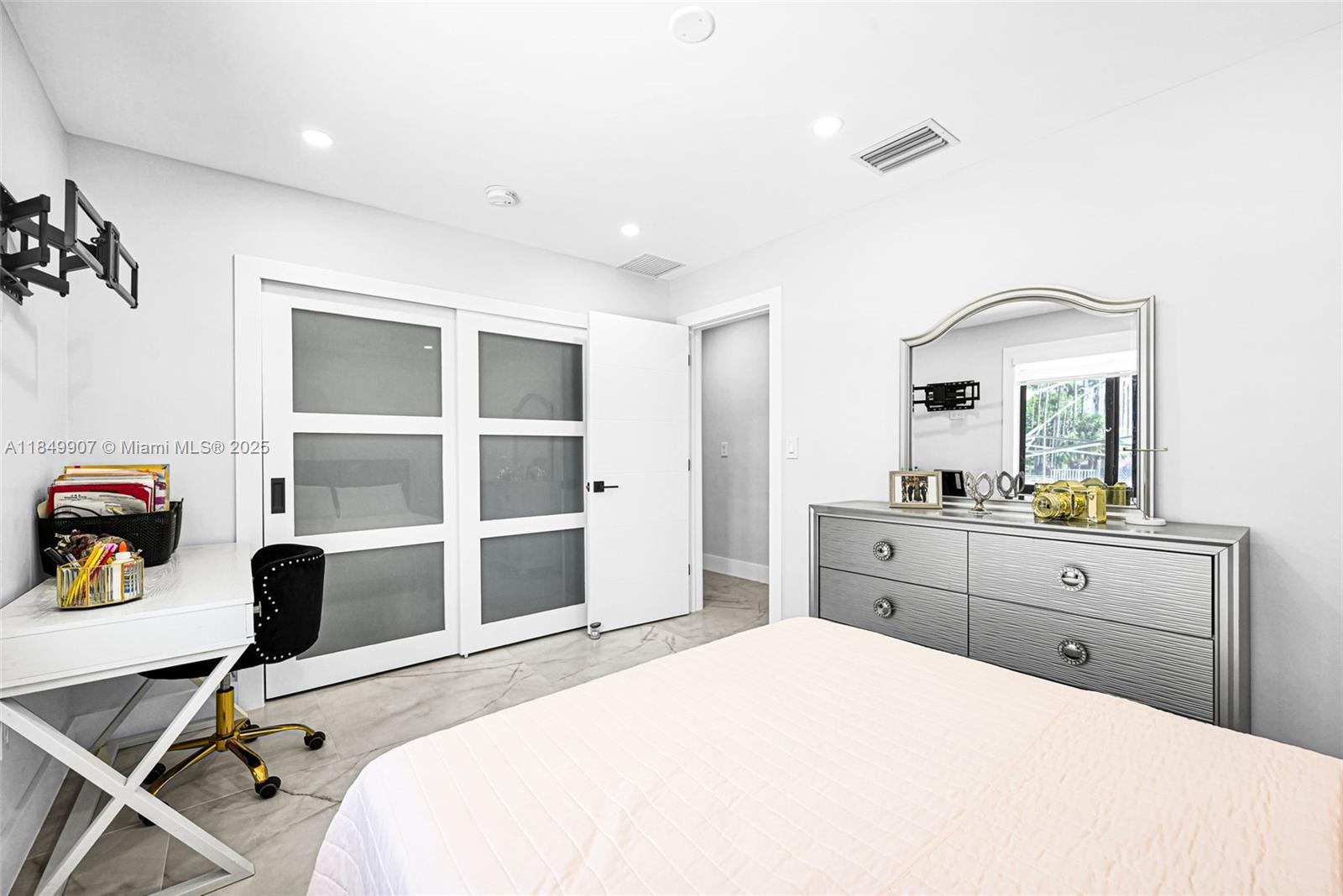 19777 Southwest 334th Street Homestead, FL 33034 - Photo 23 of 55 a bedroom with a bed and a desk