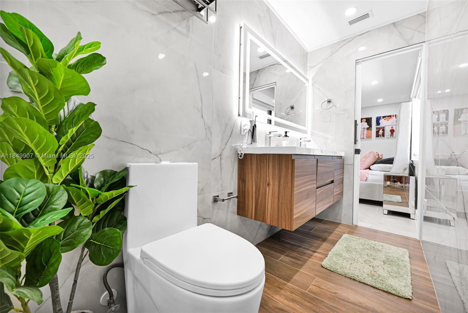 19777 Southwest 334th Street Homestead, FL 33034 - Photo 30 of 55 a living room with a potted plant and a toilet