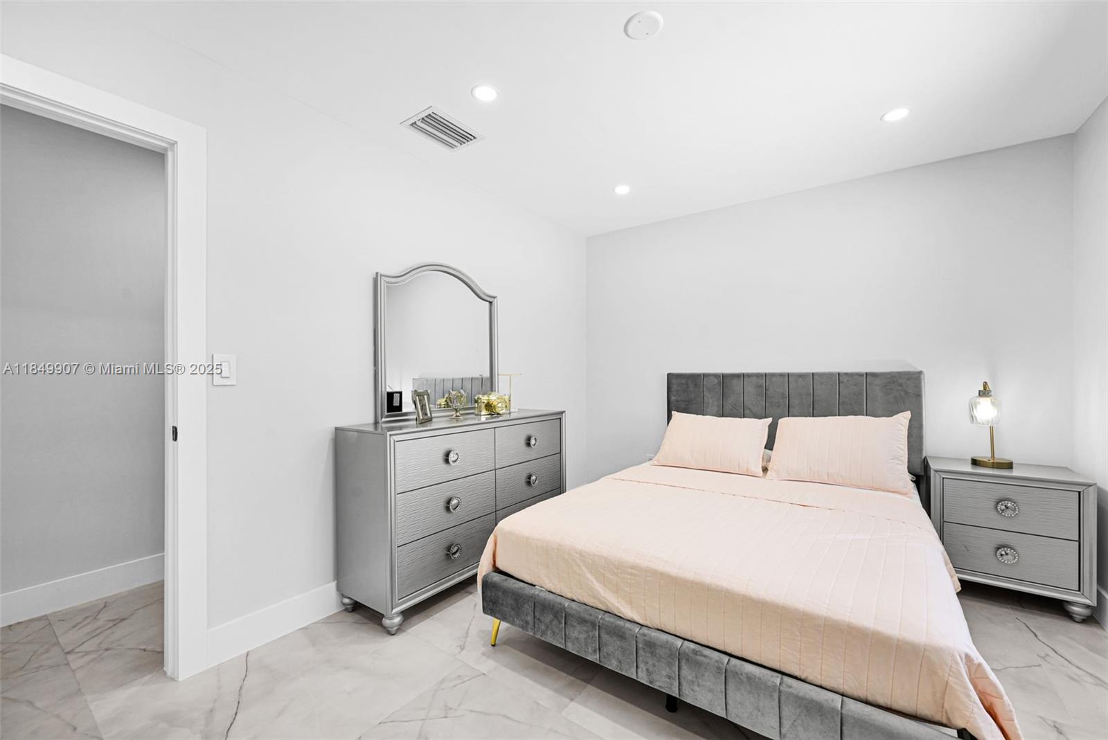 19777 Southwest 334th Street Homestead, FL 33034 - Photo 34 of 55 a bedroom with a bed and a mirror