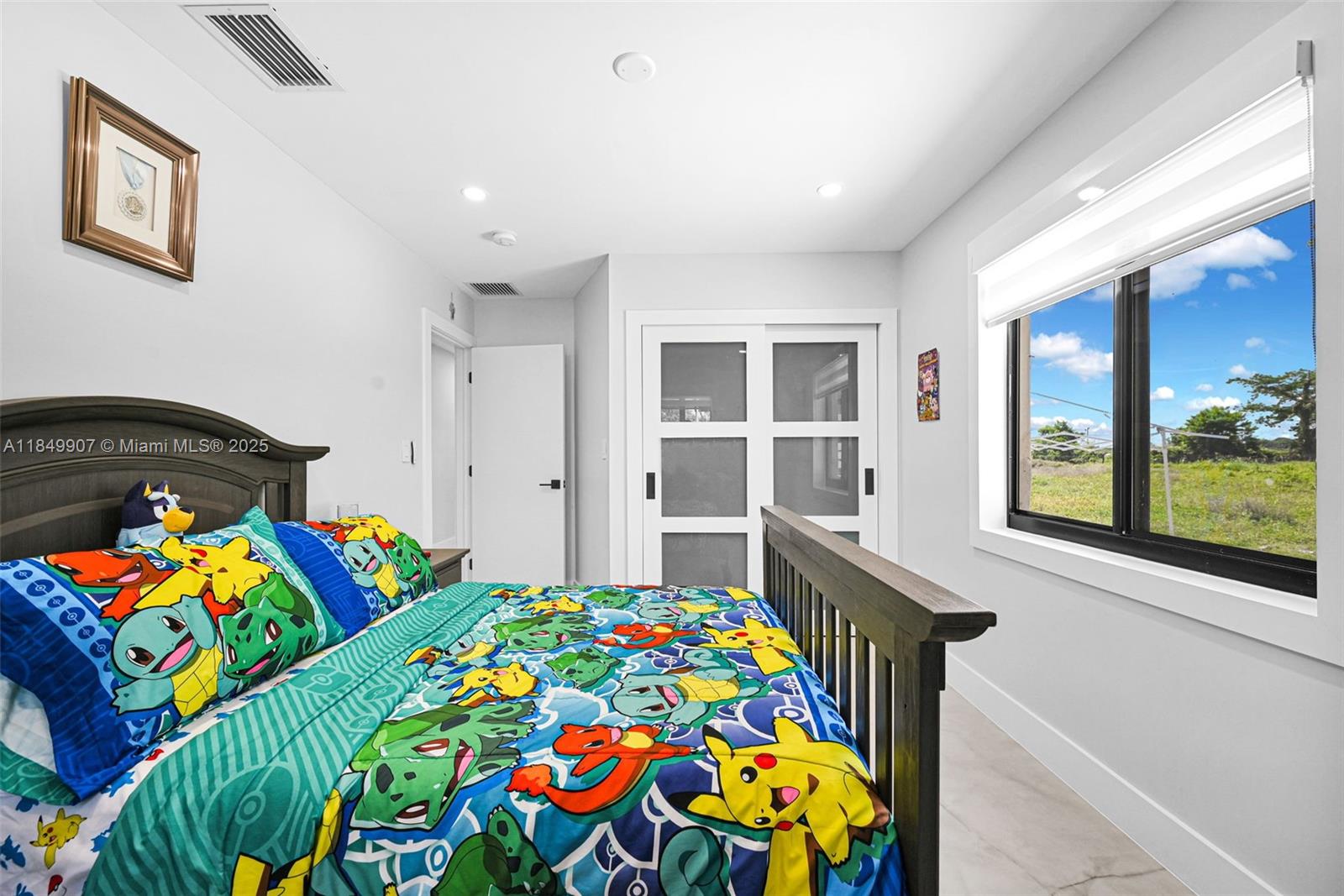 19777 Southwest 334th Street Homestead, FL 33034 - Photo 37 of 55 a bedroom with a bed and a window