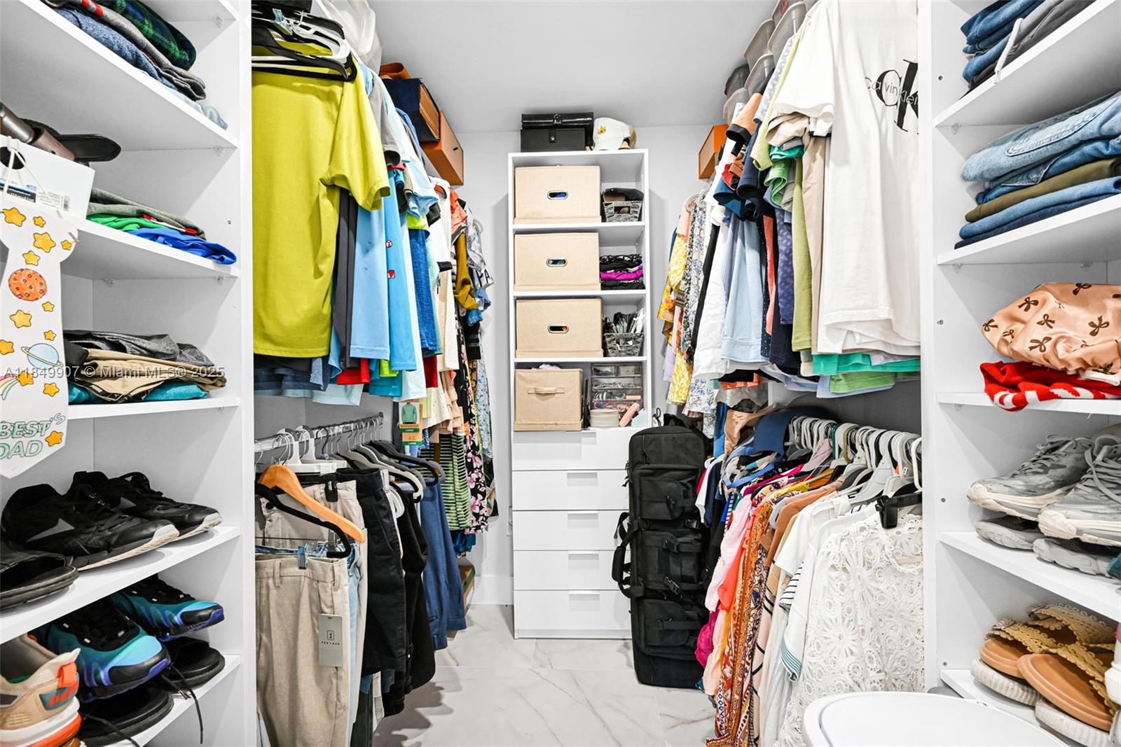 19777 Southwest 334th Street Homestead, FL 33034 - Photo 42 of 55 a view of walk in closet with clothes and shoes