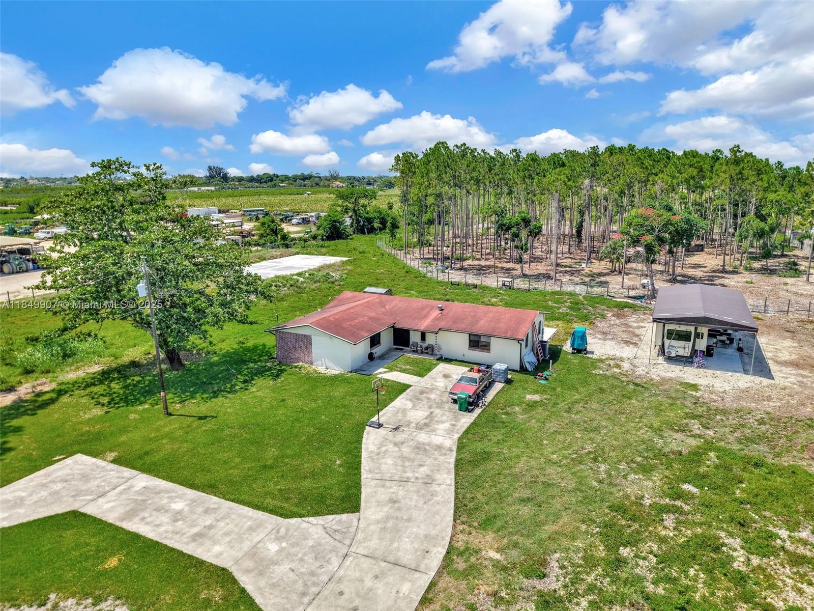 19777 Southwest 334th Street Homestead, FL 33034 - Photo 45 of 55 a view of yard with swimming pool and green space