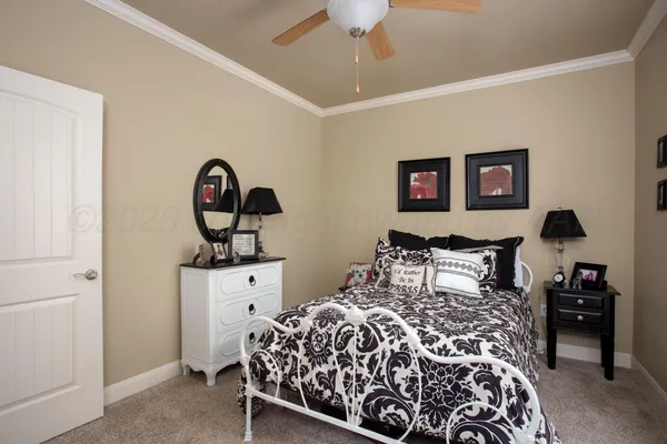 a bedroom with a large bed and a chandelier