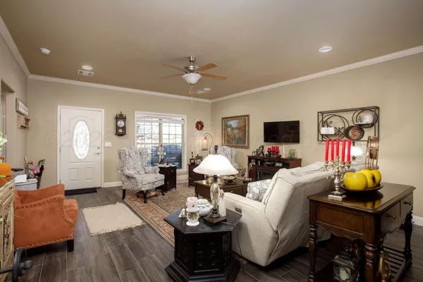 a living room with furniture and wooden floor