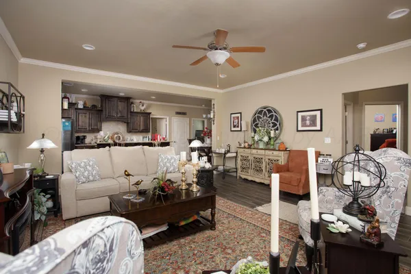 a living room with furniture and a chandelier