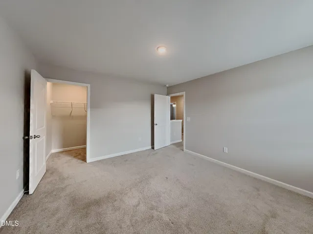 a view of an empty room and closet area
