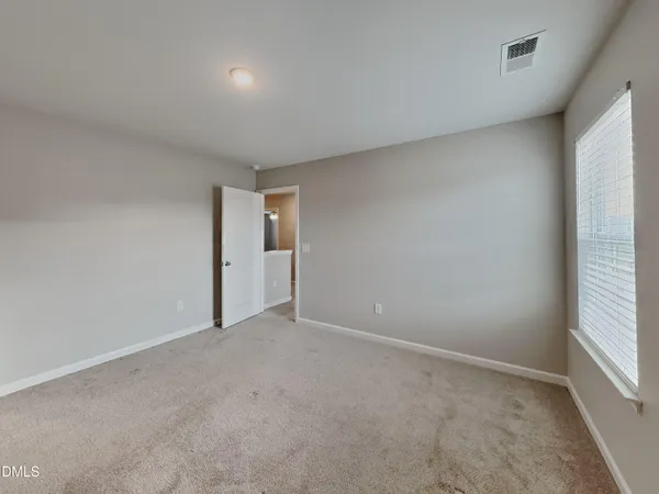 a view of an empty room and a window