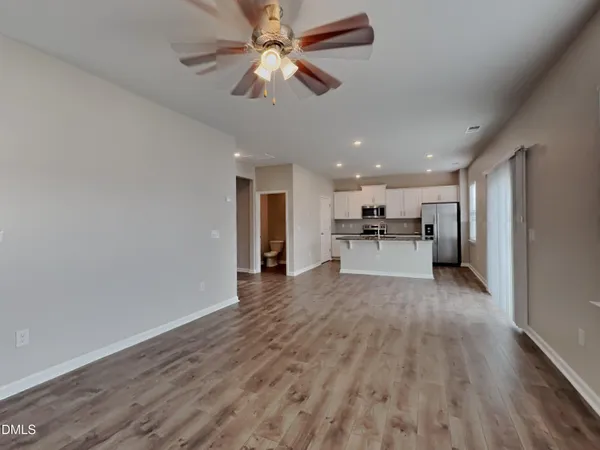 a view of a kitchen with a sink and a refrigerator