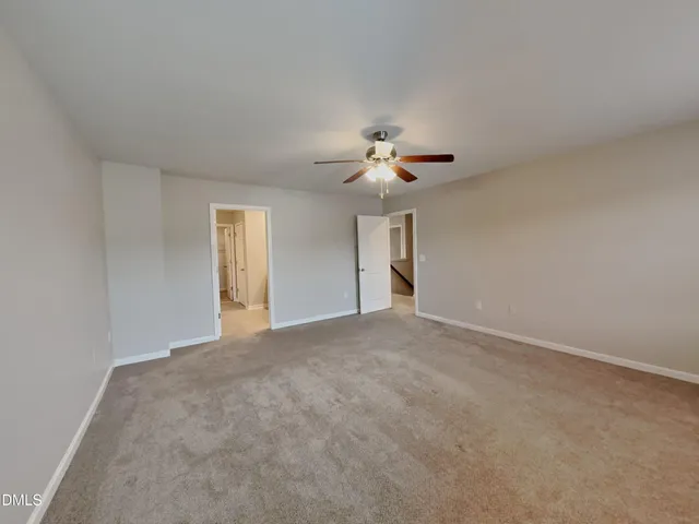 a view of a livingroom with a chandelier fan