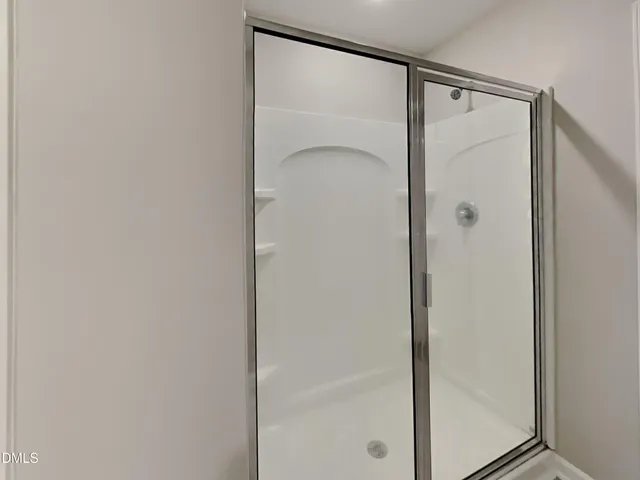 a bathroom with a glass shower door