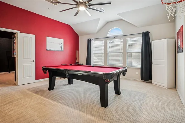 a room with pool table and windows