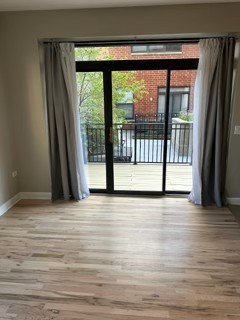 1529 South State Street, Unit 4B Chicago, IL 60605 - Photo 4 of 16 a view of an empty room with wooden floor and a window