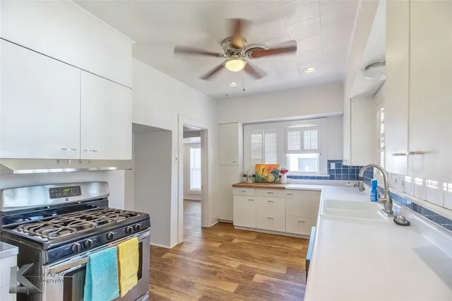 a kitchen with a stove a refrigerator and a sink