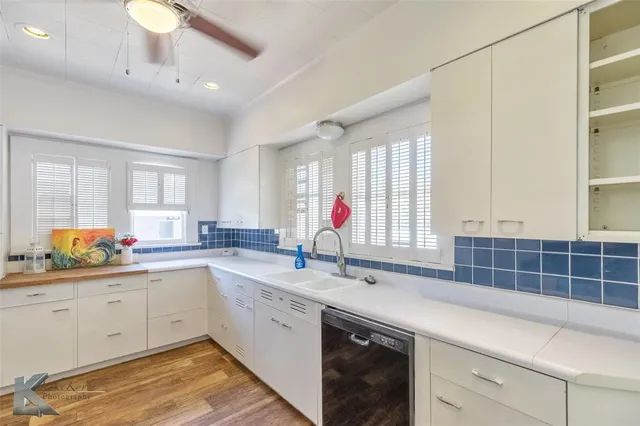 a kitchen with sink cabinets and window