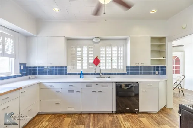 a kitchen with a sink stove and cabinets