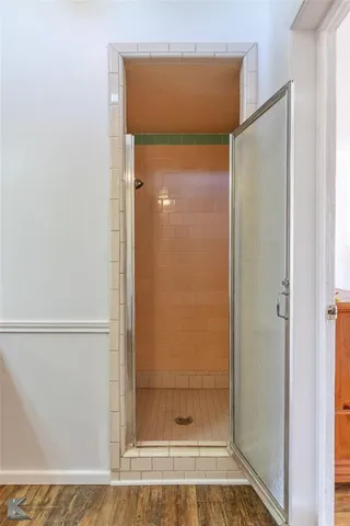 a bathroom with a glass shower door