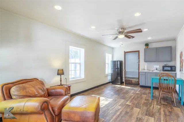 a living room with furniture and a wooden floor