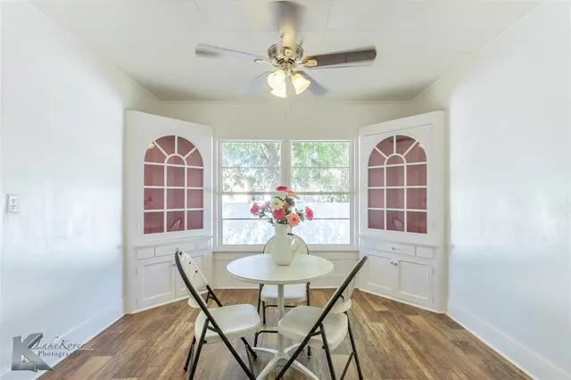 a dining room with furniture window and wooden floor