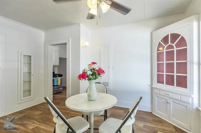 a view of a dining room with furniture and a potted plant