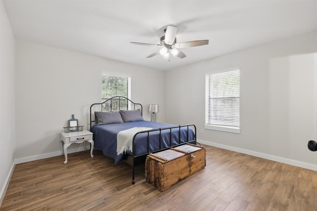 2446 Neely Trail Valley View, TX 76272 - Photo 21 of 29 a spacious bedroom with a bed and window
