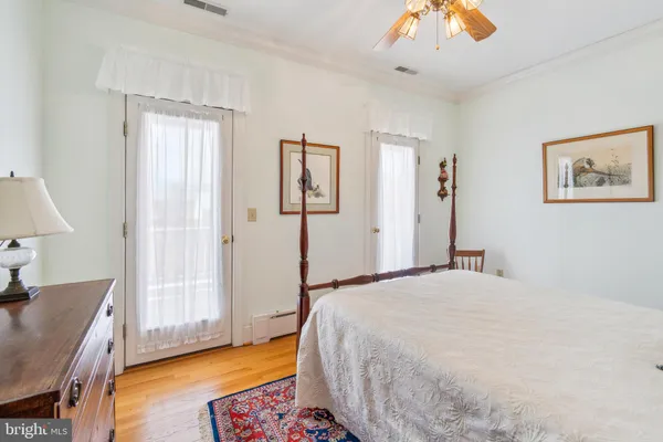 a spacious bedroom with a bed and a chandelier