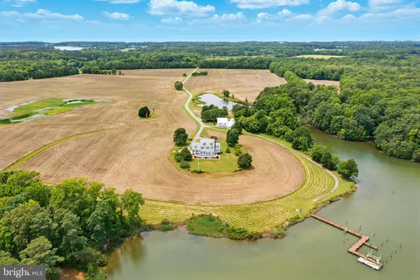 an aerial view of a house with outdoor space and lake view