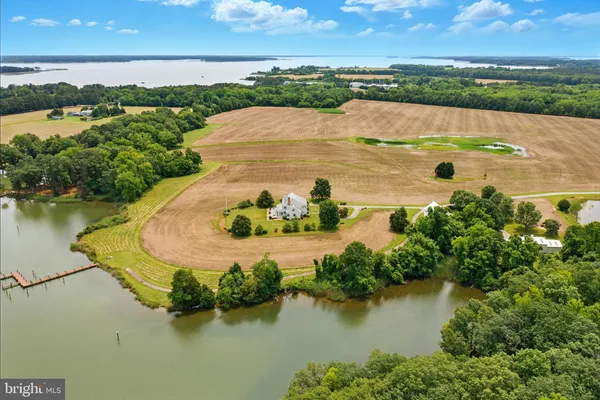 an aerial view of residential houses with outdoor space and lake view