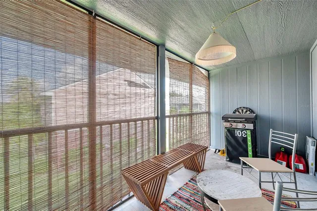 a dining room with furniture and a floor to ceiling window