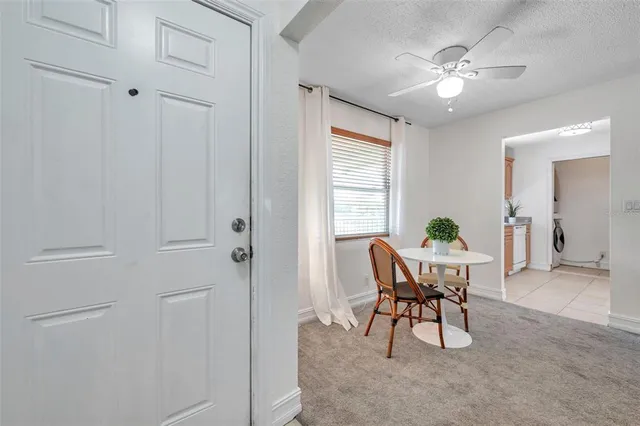 a view of a dining room with furniture and window