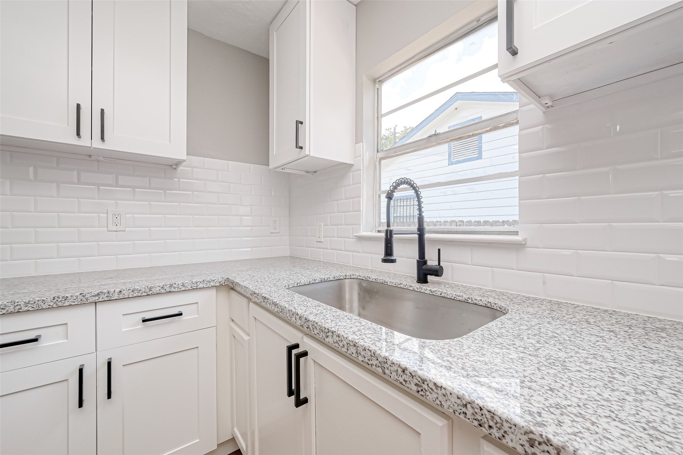 6715 Victoria Street Houston, TX 77020 - Photo 17 of 46 a kitchen with granite countertop a sink and cabinets