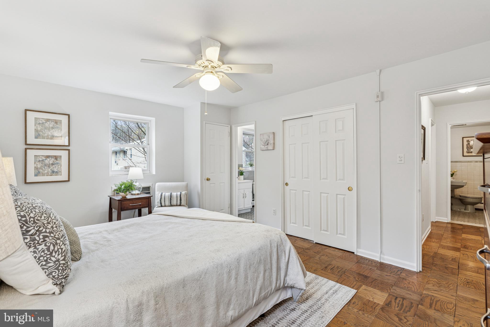 412 North Wayne Avenue, Unit 108 Wayne, PA 19087 - Photo 12 of 17 a bedroom with a large bed and a chandelier