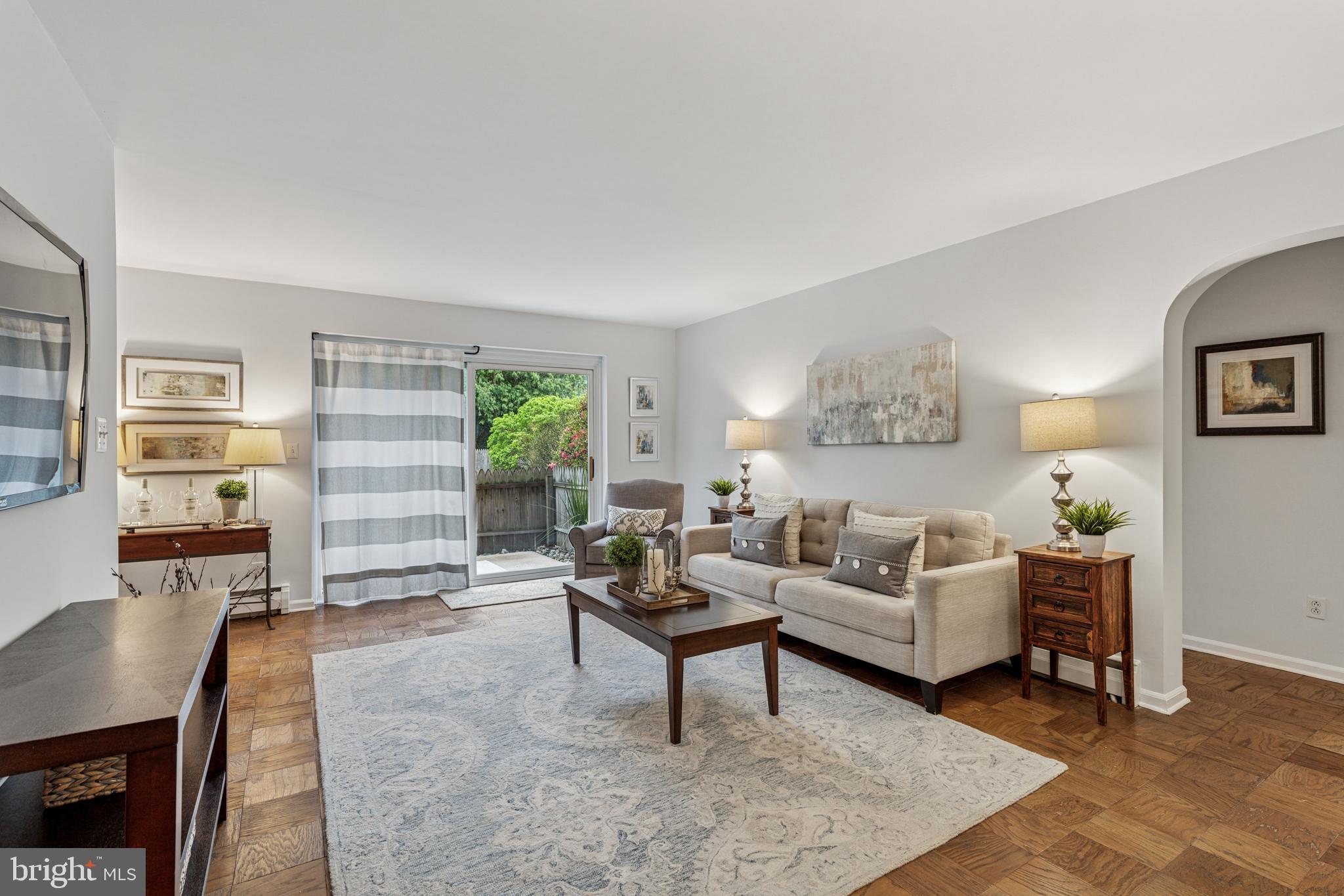 412 North Wayne Avenue, Unit 108 Wayne, PA 19087 - Photo 3 of 17 a living room with furniture and wooden floor