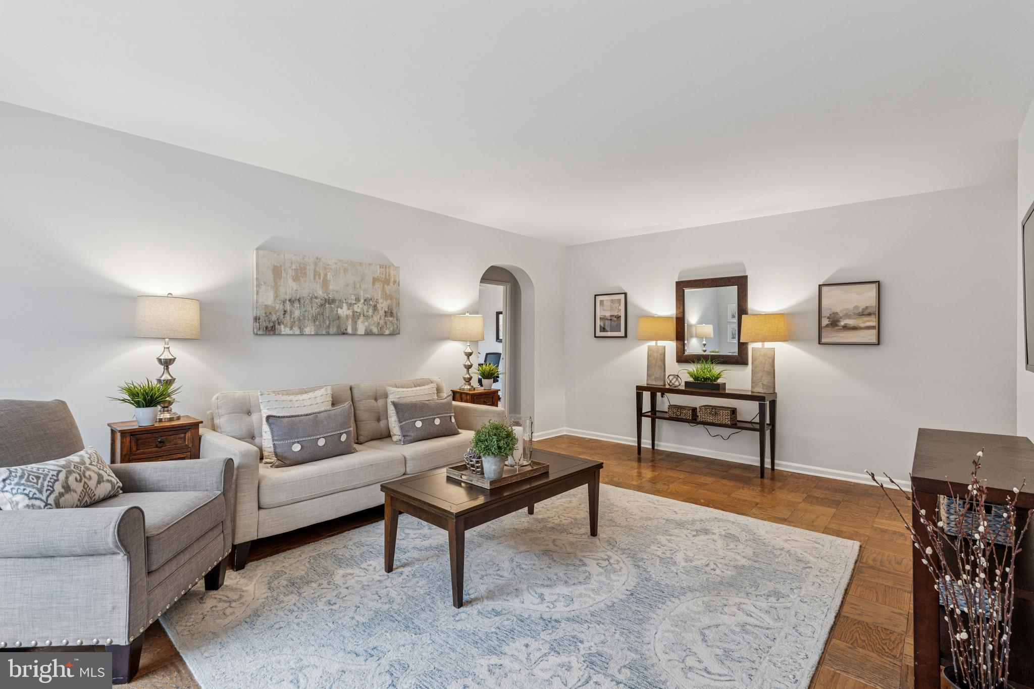 412 North Wayne Avenue, Unit 108 Wayne, PA 19087 - Photo 4 of 17 a living room with furniture and a wooden floor