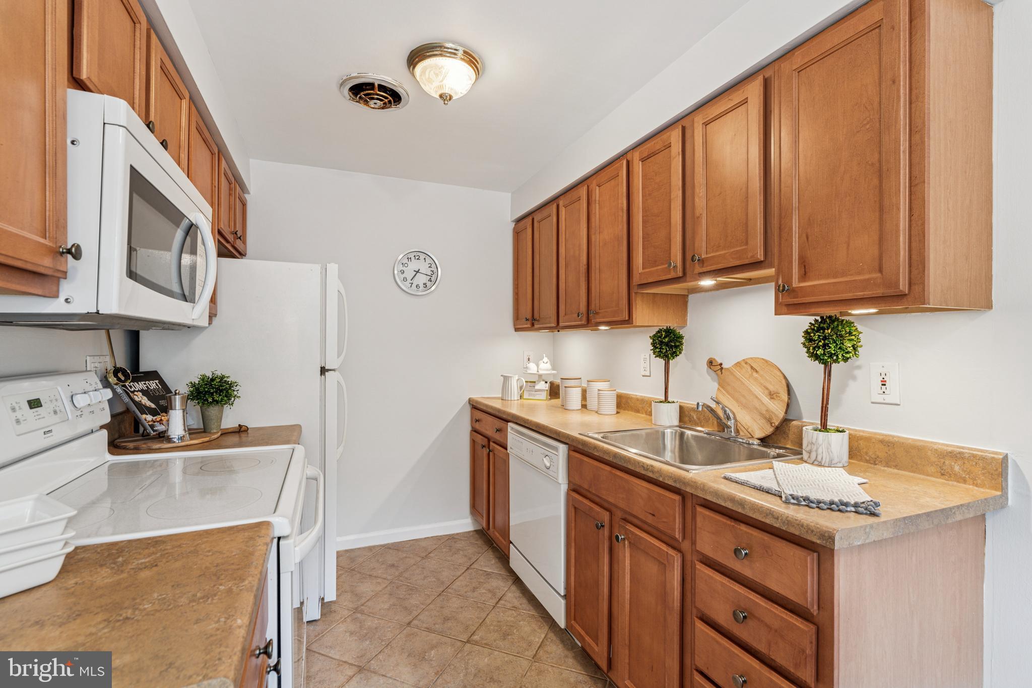 412 North Wayne Avenue, Unit 108 Wayne, PA 19087 - Photo 8 of 17 a kitchen with stainless steel appliances granite countertop a sink stove and cabinets