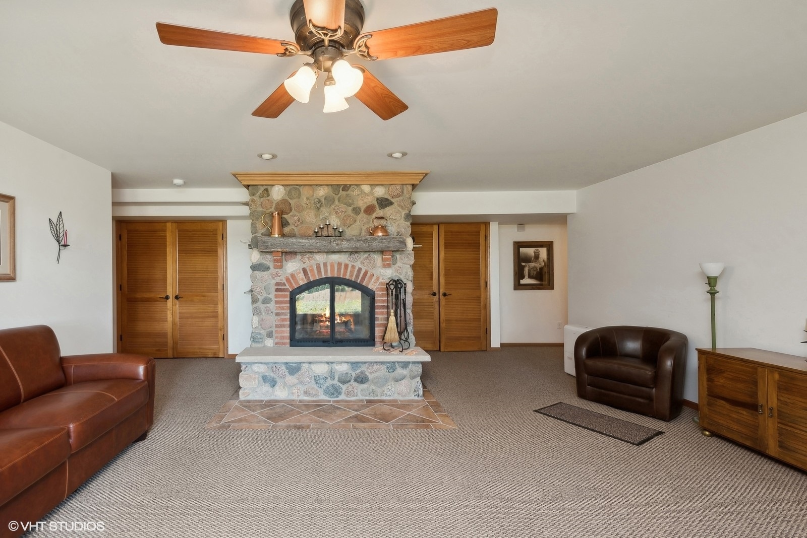N3317 Schmidt Road Jefferson, WI 53549 - Photo 30 of 51 a living room with furniture a ceiling fan and a fireplace