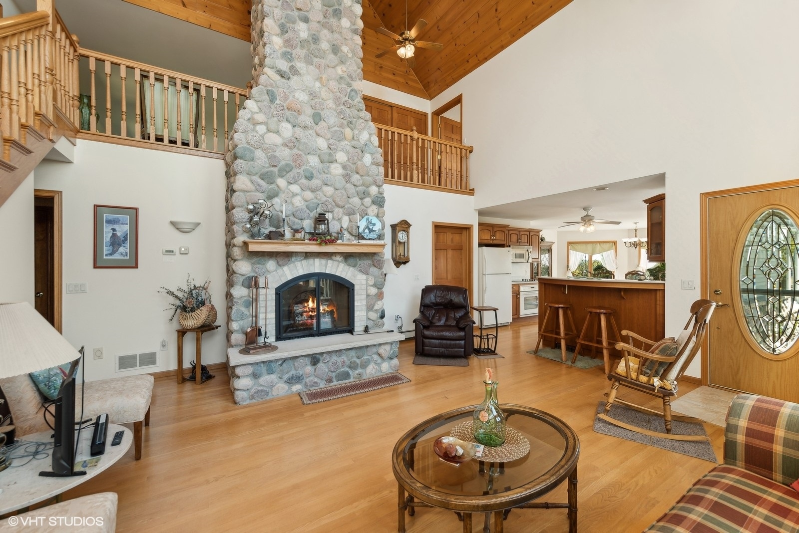 N3317 Schmidt Road Jefferson, WI 53549 - Photo 8 of 51 a living room with furniture a fireplace and a dining table with wooden floor