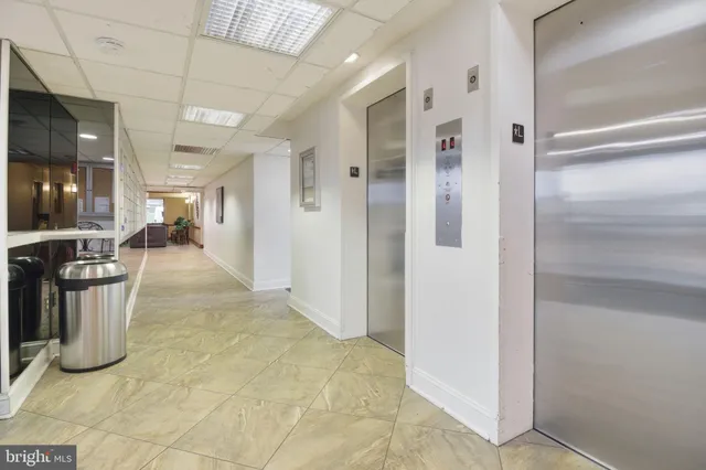 a living room with couches and kitchen view