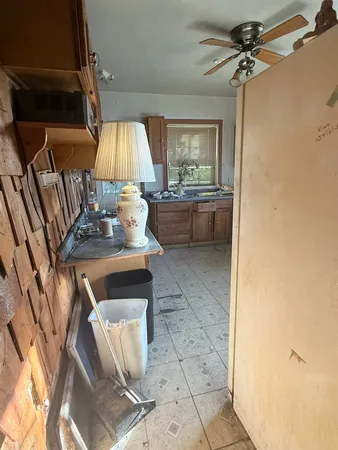 a kitchen with stainless steel appliances a sink a stove a refrigerator and cabinets