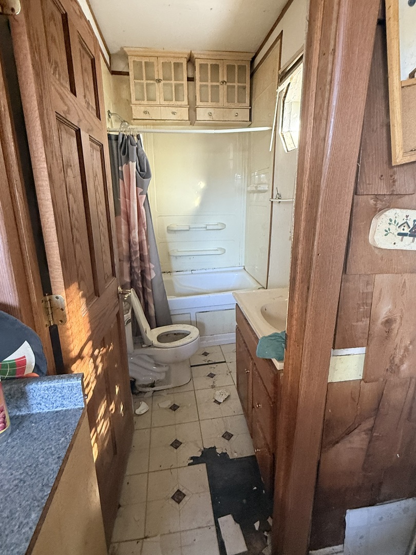 445 155th Place Calumet City, IL 60409 - Photo 10 of 14 a bathroom with a sink a toilet and shower