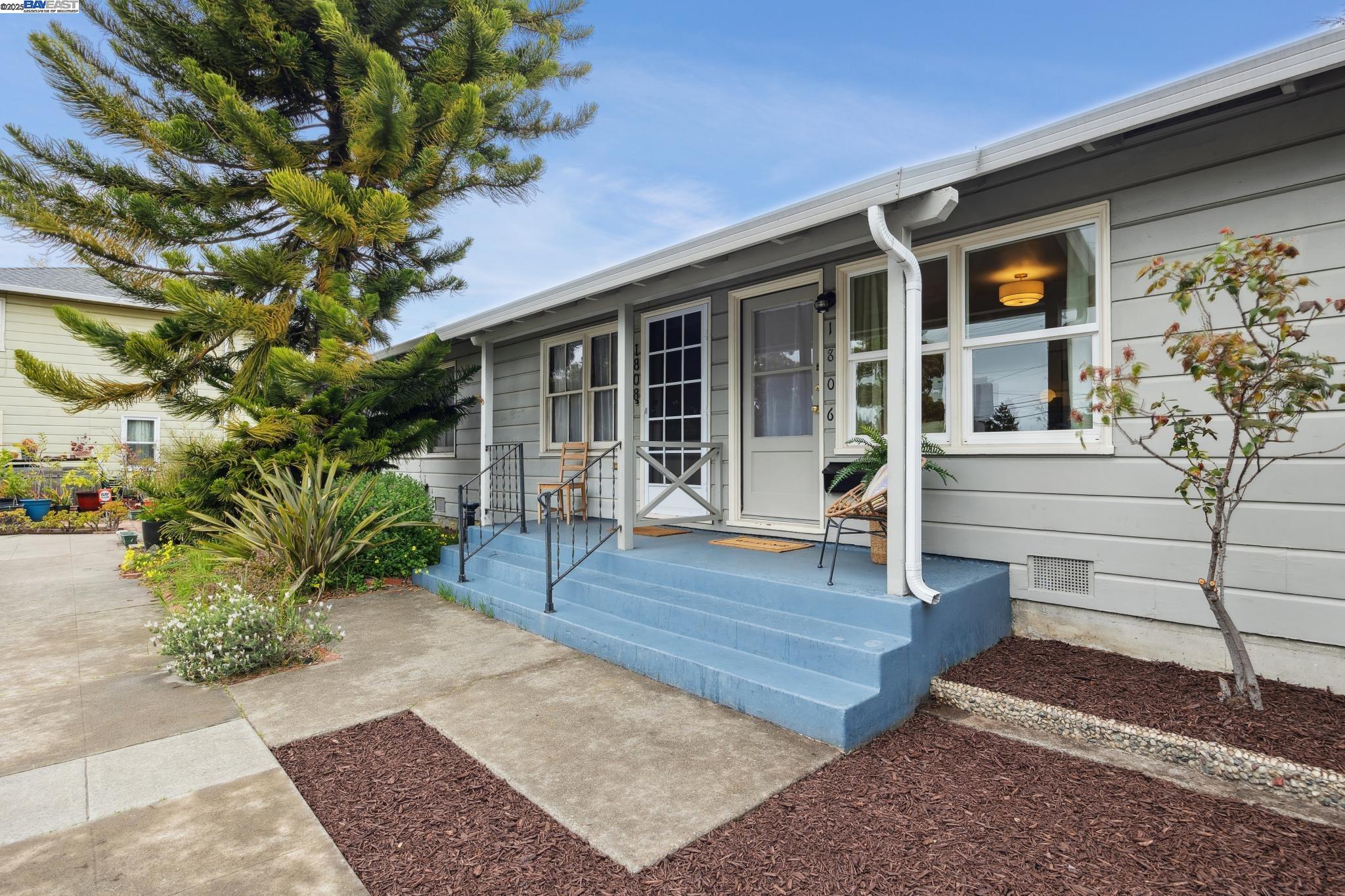 a view of house with wooden deck and furniture