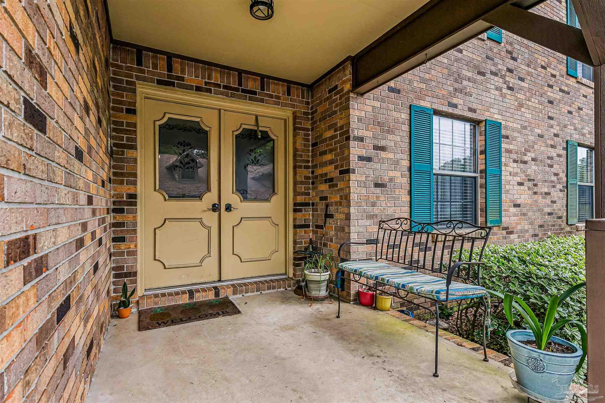 4831 East Olive Road, Unit 2D Pensacola, FL 32514 - Photo 6 of 29 a front view of a house with entryway