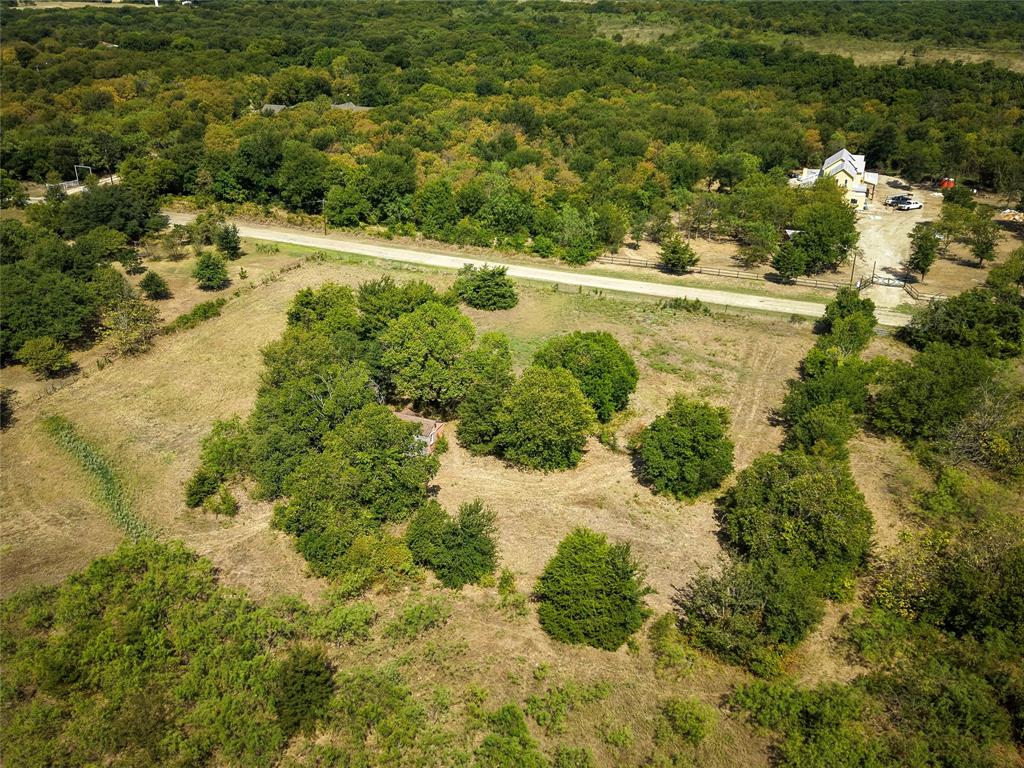 Tbd Stacks Road Ennis, TX 75119 - Photo 19 of 24 Expansive land parcel featuring mature trees, open clearings, and a gravel road