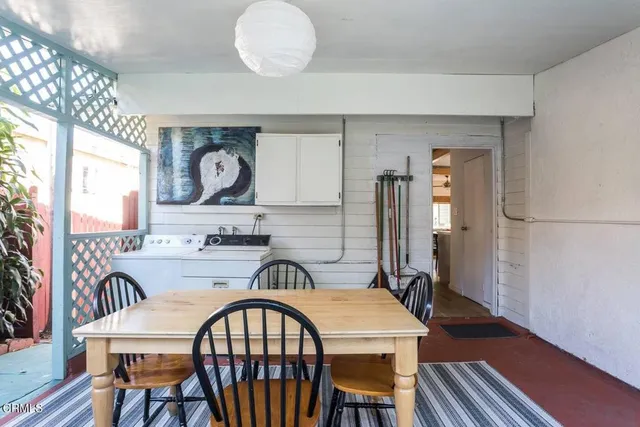 a view of a a dining room with furniture window and wooden floor