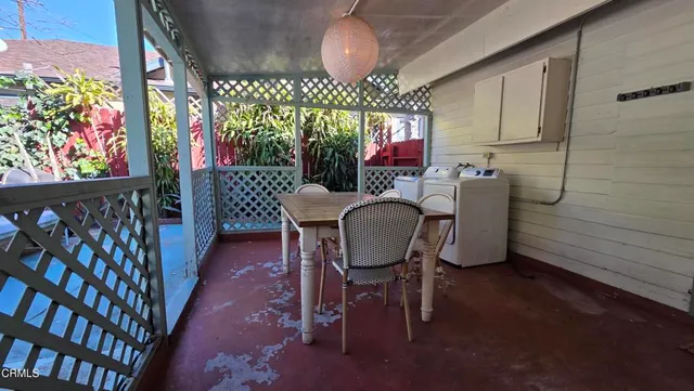 a view of a dining room with furniture a chandelier and wooden floor