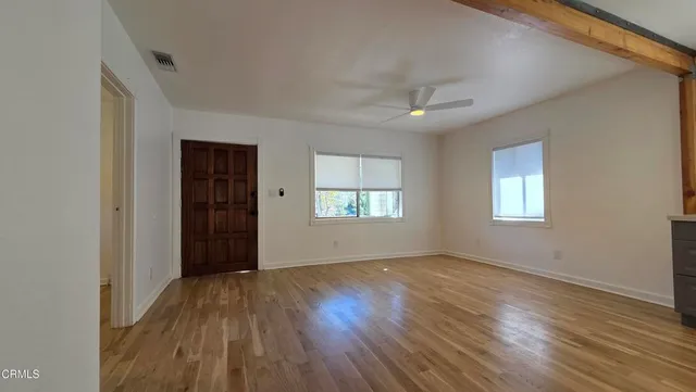 wooden floor in an empty room with a window