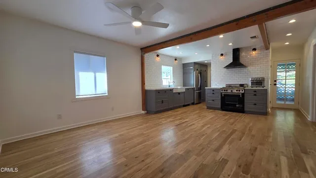a large kitchen with stainless steel appliances granite countertop a stove and a sink