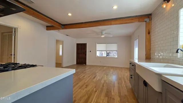 a view of a kitchen cabinets a sink and wooden floor