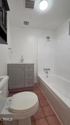 a bathroom with a toilet and a bathtub