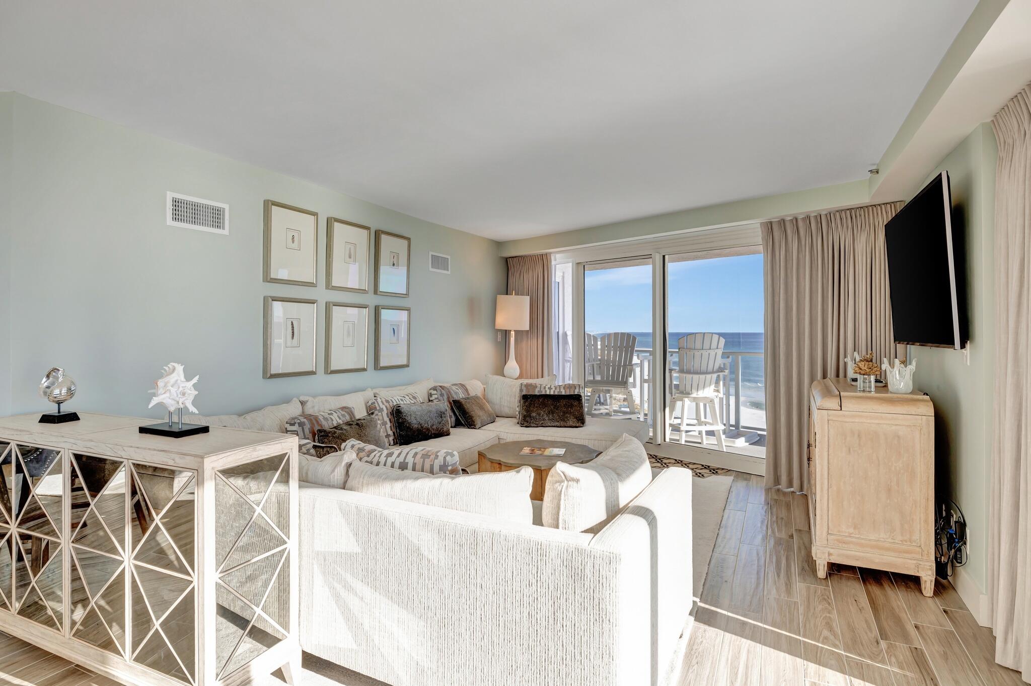 4323 Beachside 2, Unit 323 Miramar Beach, FL 32550 - Photo 12 of 41 a living room with furniture a flat screen tv and a floor to ceiling window