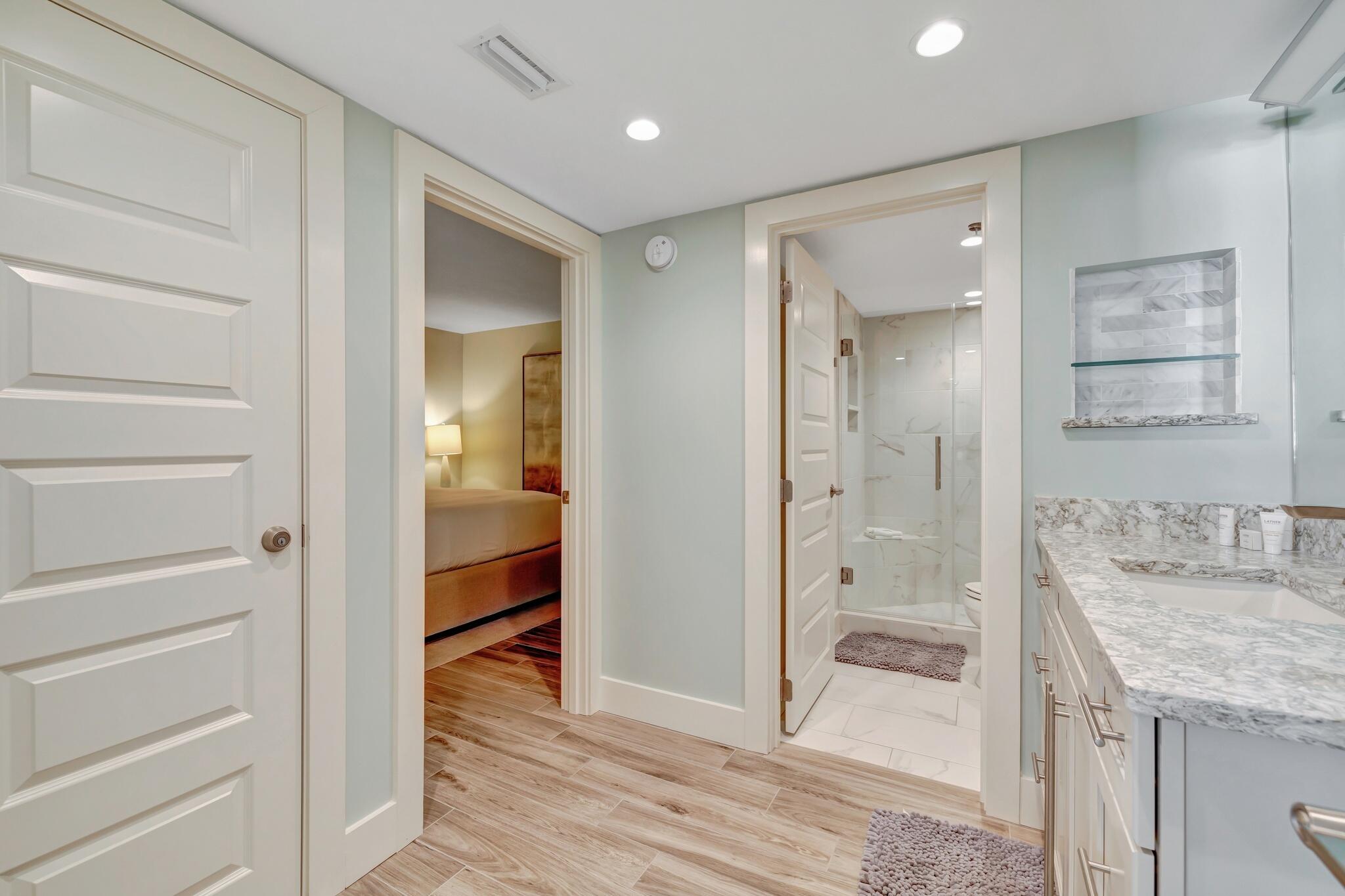 4323 Beachside 2, Unit 323 Miramar Beach, FL 32550 - Photo 22 of 41 a bathroom with a granite countertop sink mirror and shower